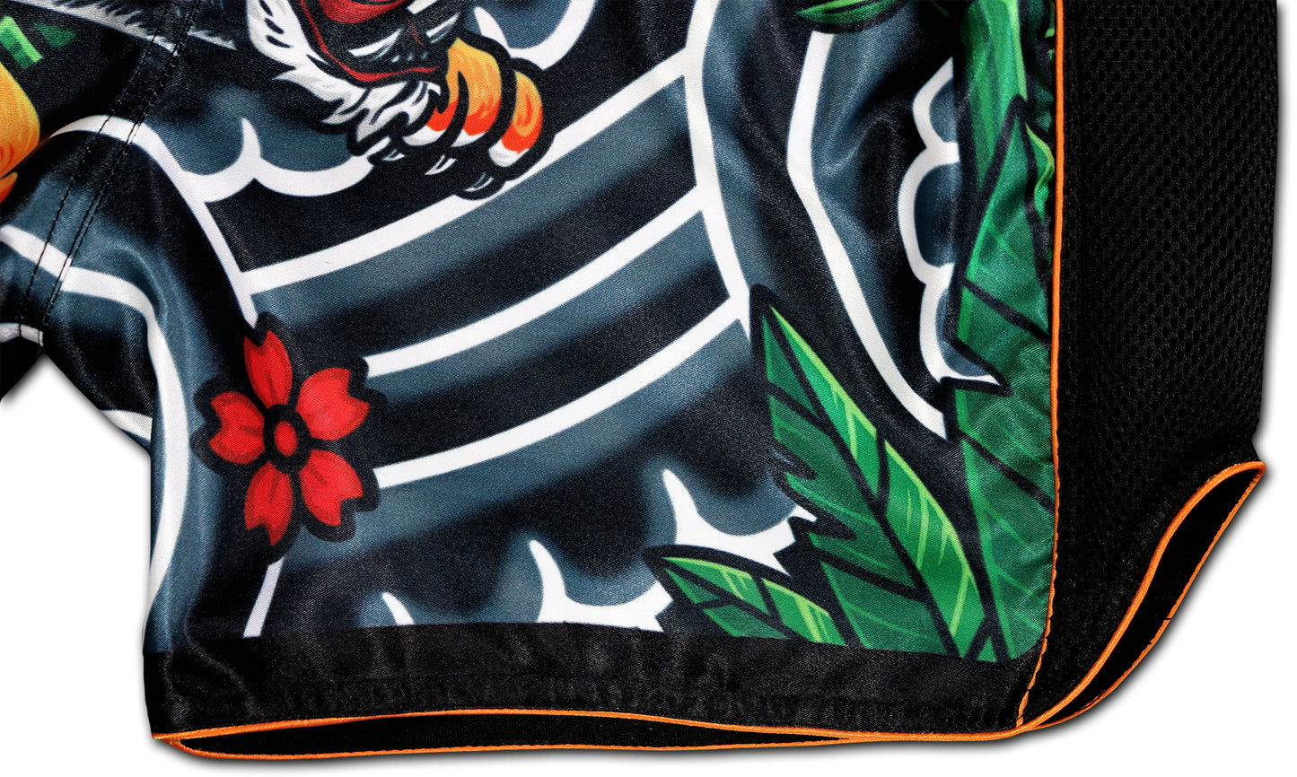 Detail view of Irezumi Tiger Muay Thai Shorts showing red flower, green leaves, black mesh side panel, and orange piping β premium sublimated fabric
