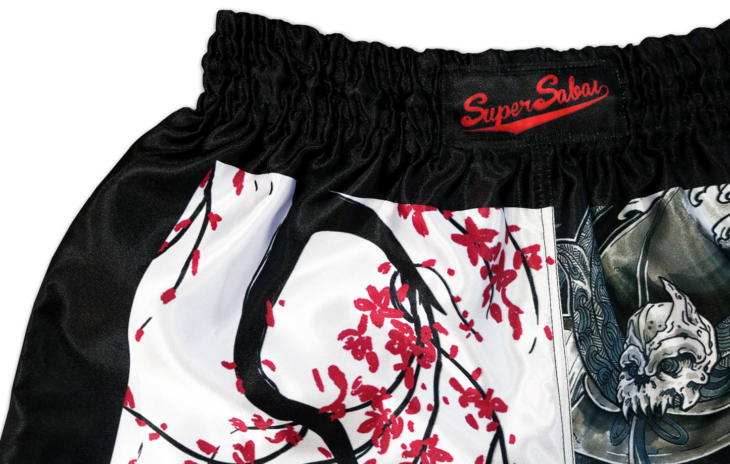 Close-up of the Sakura Muay Thai Shorts waistband, showcasing the Super Sabai logo and intricate sakura tree design, handcrafted in Thailand by our family business.
