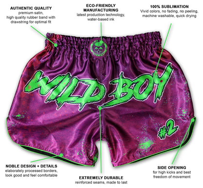 Wild Boy Muay Thai Shorts in shiny purple satin with neon green graffiti lettering and paint splatter, shown with infographic labels highlighting premium satin quality, eco-friendly water-based inks, 100% sublimation for vivid colors, noble design details, extreme durability with reinforced seams, and side opening for high kicks, handmade in Thailand, extreme limited edition, customizable with name.
