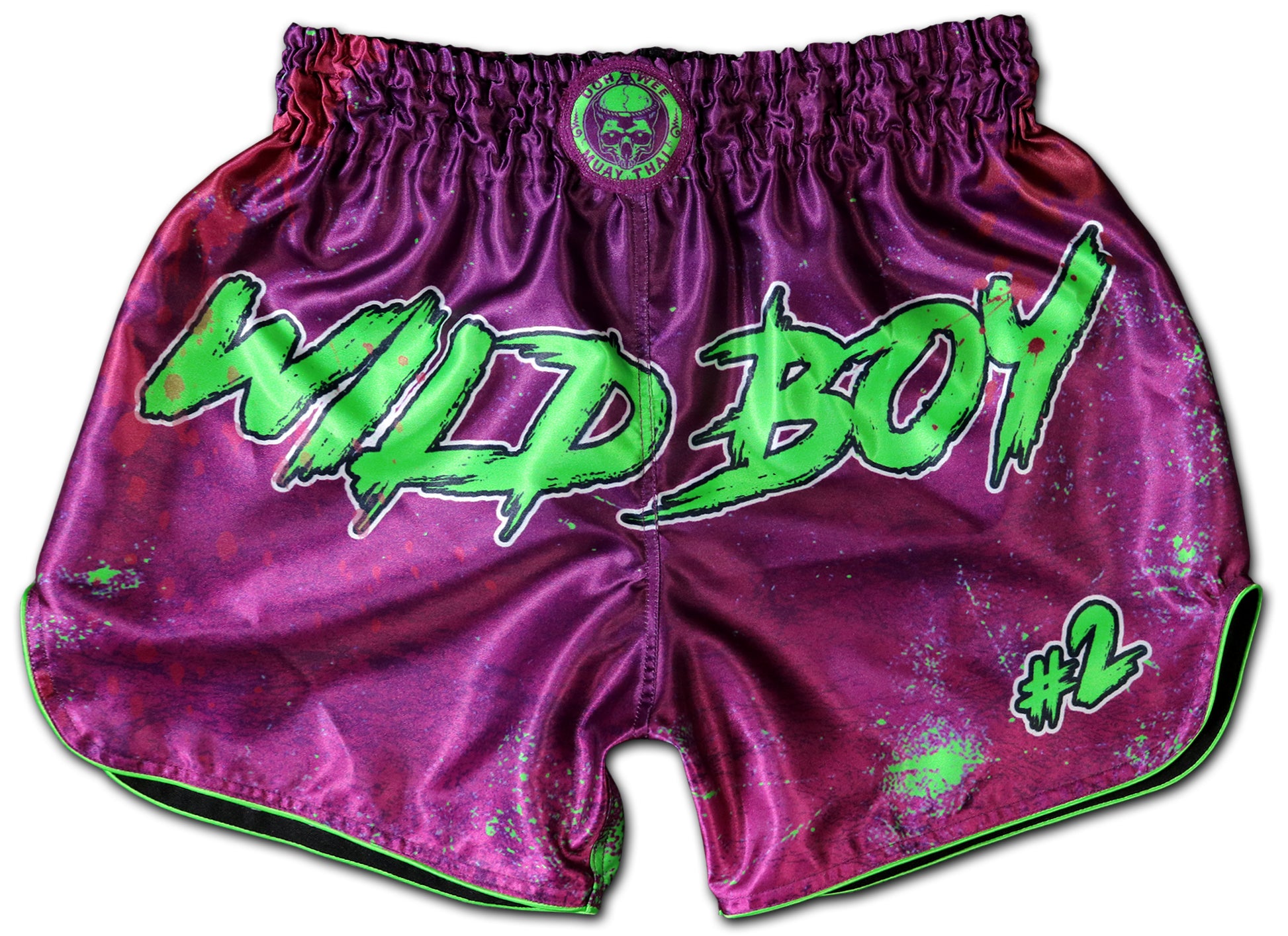 Wild Boy Muay Thai Shorts in shiny purple satin with neon green graffiti lettering, paint splatter design, elastic waistband, handmade in Thailand, customizable with name, extreme limited edition.