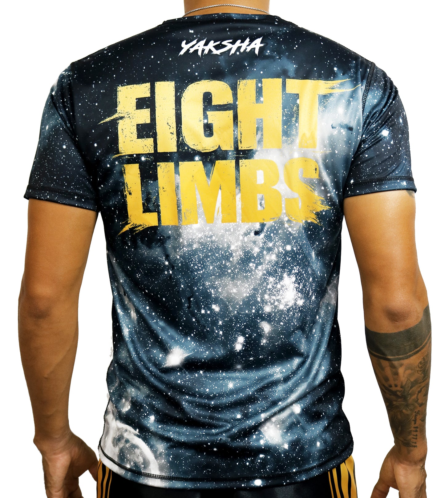 YAKSHA 8 Limbs Universe Muay Thai t-shirt worn by model, back view showing Eight Limbs lettering and YAKSHA logo on galaxy print
