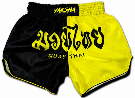 YAKSHA Luk Krung two-tone Muay Thai Shorts in black and yellow with Thai script and MUAY THAI lettering handmade in Hua Hin Thailand