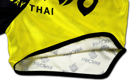 Close-up of the YAKSHA Luk Krung Muay Thai Shorts inner lining with YAKSHA logo pattern and reinforced black seam