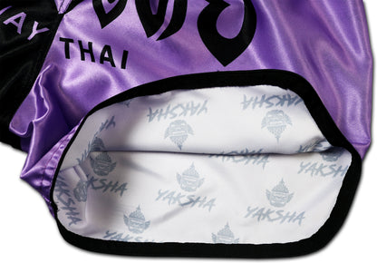 YAKSHA Luk Krung Muay Thai Shorts Black Lavender – detail picture of side opening revealing exclusive all-over YAKSHA signature logo print on the interior satin, a premium branding detail that sets these shorts apart