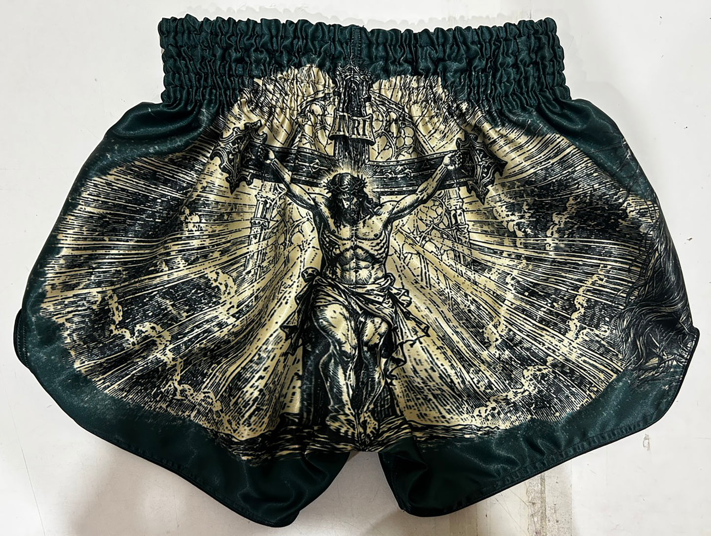 Custom-made Muay Thai Shorts Dark Green, Back View with Full Crucifixion Print in Gold and Black Engraving Style