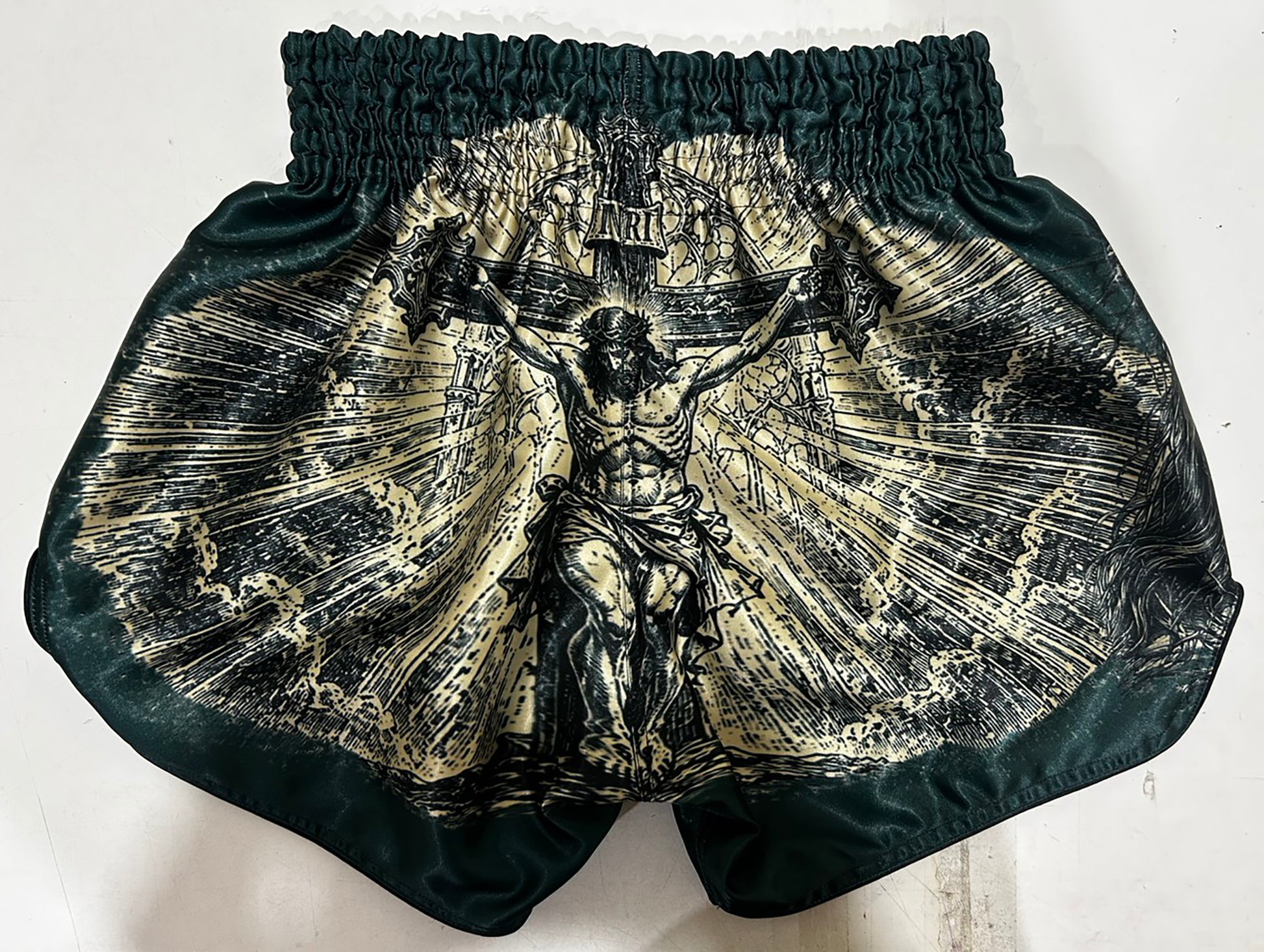 Custom-made Muay Thai Shorts Dark Green, Back View with Full Crucifixion Print in Gold and Black Engraving Style
