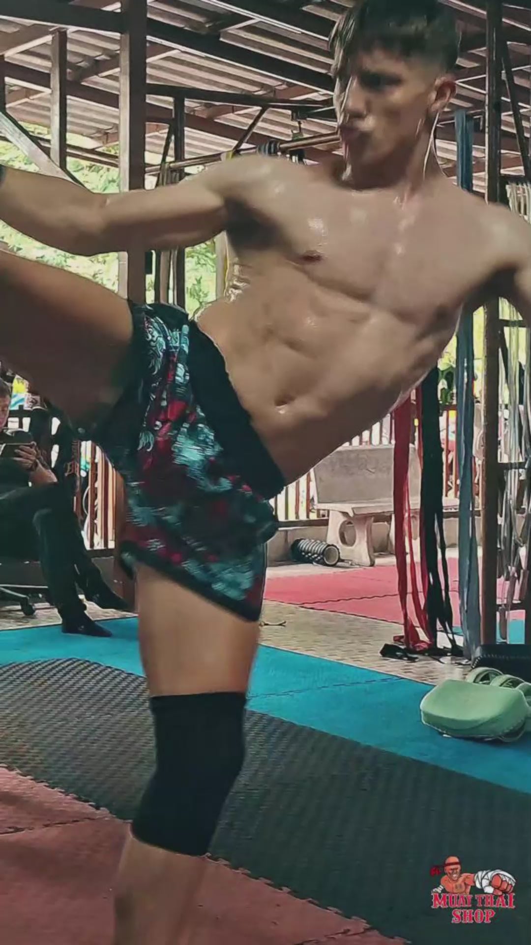Muay Thai Fighter is wearing the Devils Koi Muay Thai shorts while shadow boxing, punching and kicking in the gym