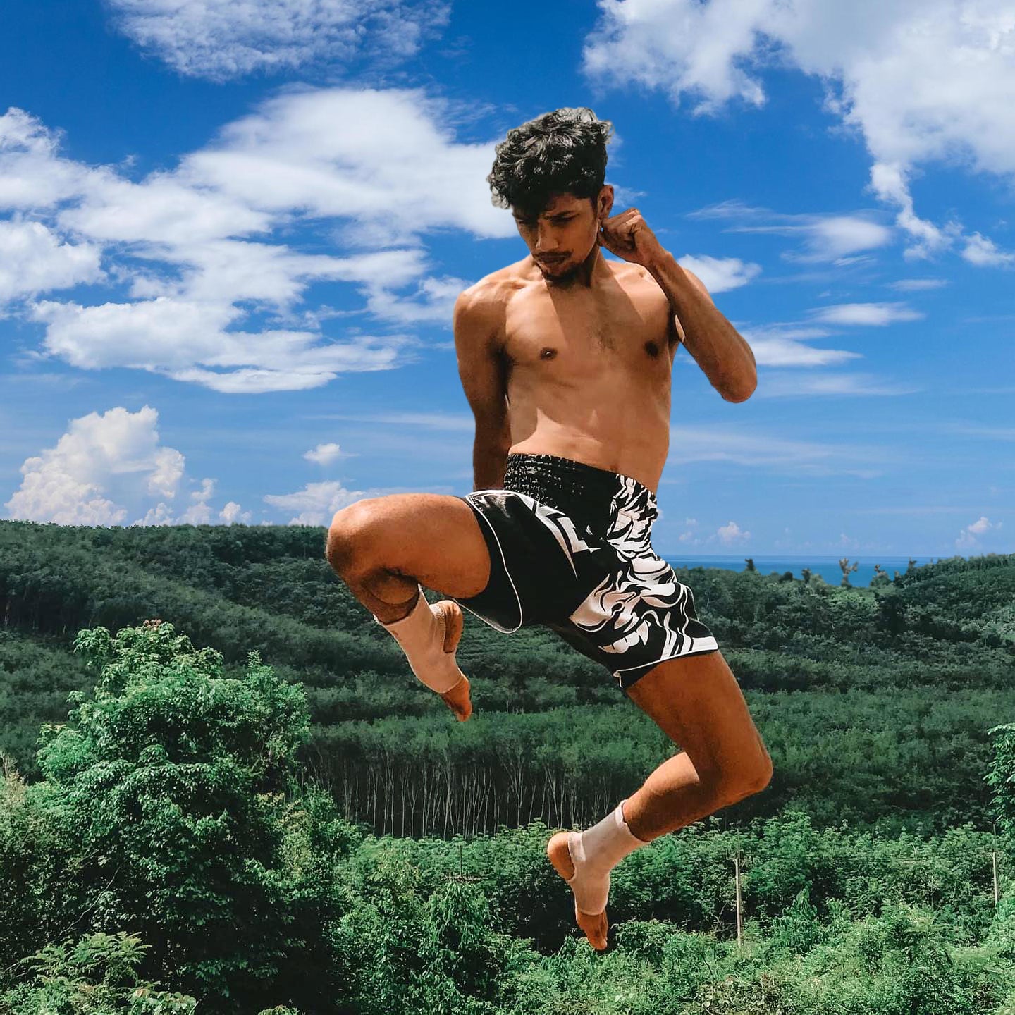 famous instragram influencer BAO wearing Tribal Samurai Muay Thai Boxing Shorts in black and white during high knee kick
