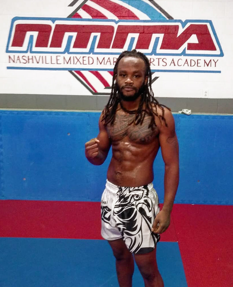 Customer wearing Tribal Samurai Muay Thai Boxing Shorts in white and black during MMA training