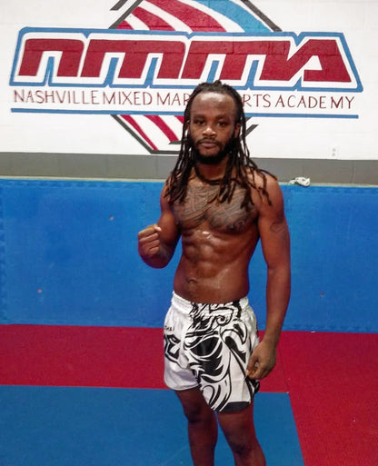 Customer wearing Tribal Samurai Muay Thai Boxing Shorts in white and black during MMA training