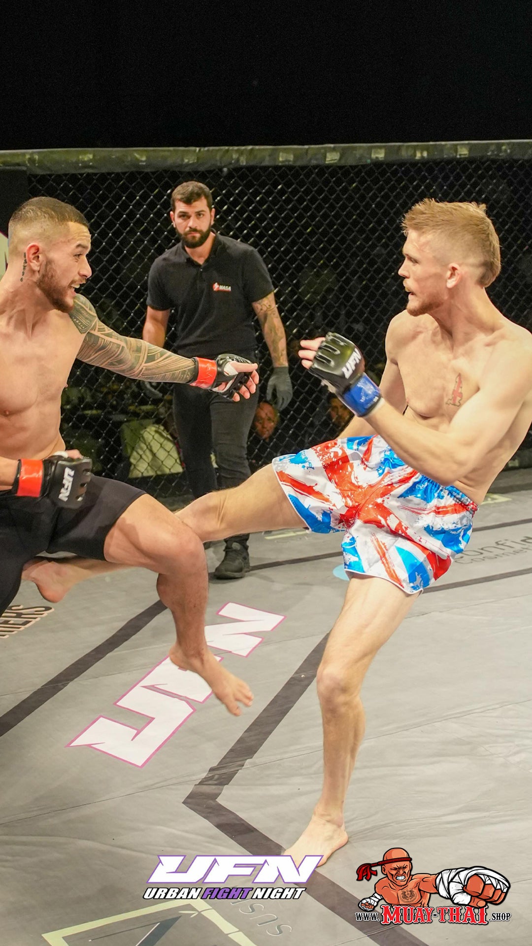 a fighter in the ring is wearing the Union Jack fight shorts and landing a clean kick to his oponent