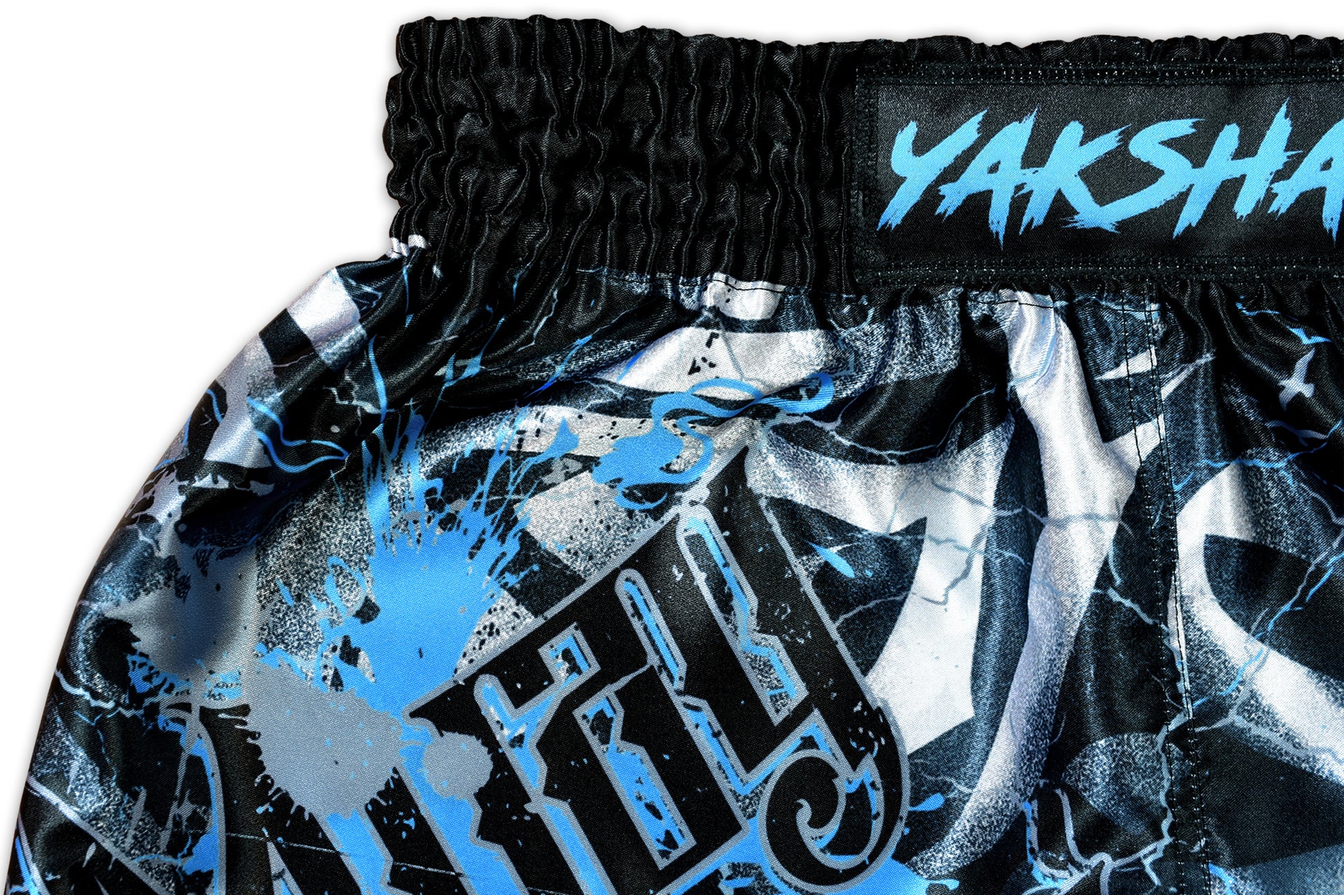 Close up of electric blue YAKSHA demon face panel and cracked lightning pattern on black satin