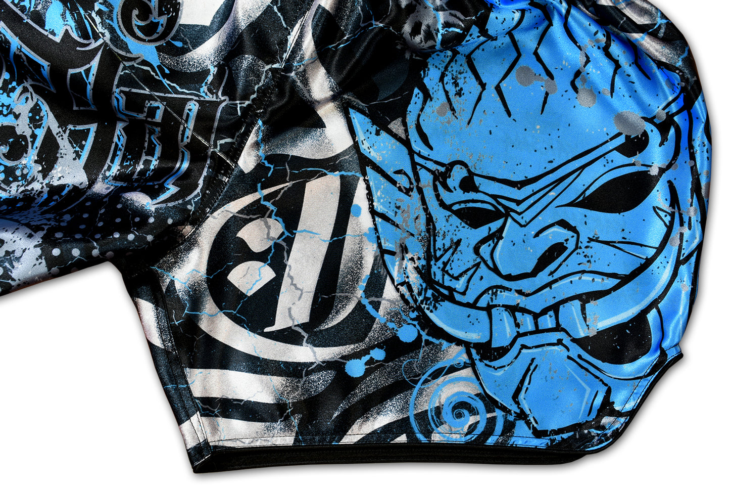 Detail of black satin waistband with electric blue YAKSHA logo and blue lightning sublimation on YAKSHA Demons fight shorts