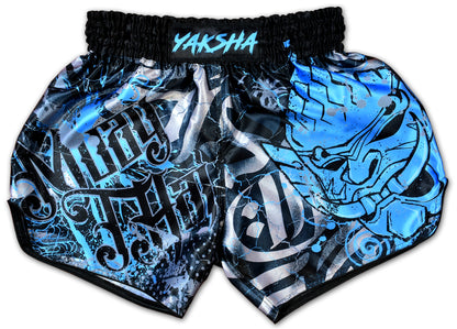 YAKSHA Demons Thai boxing shorts front view, black base with electric blue demon face and silver grunge lettering