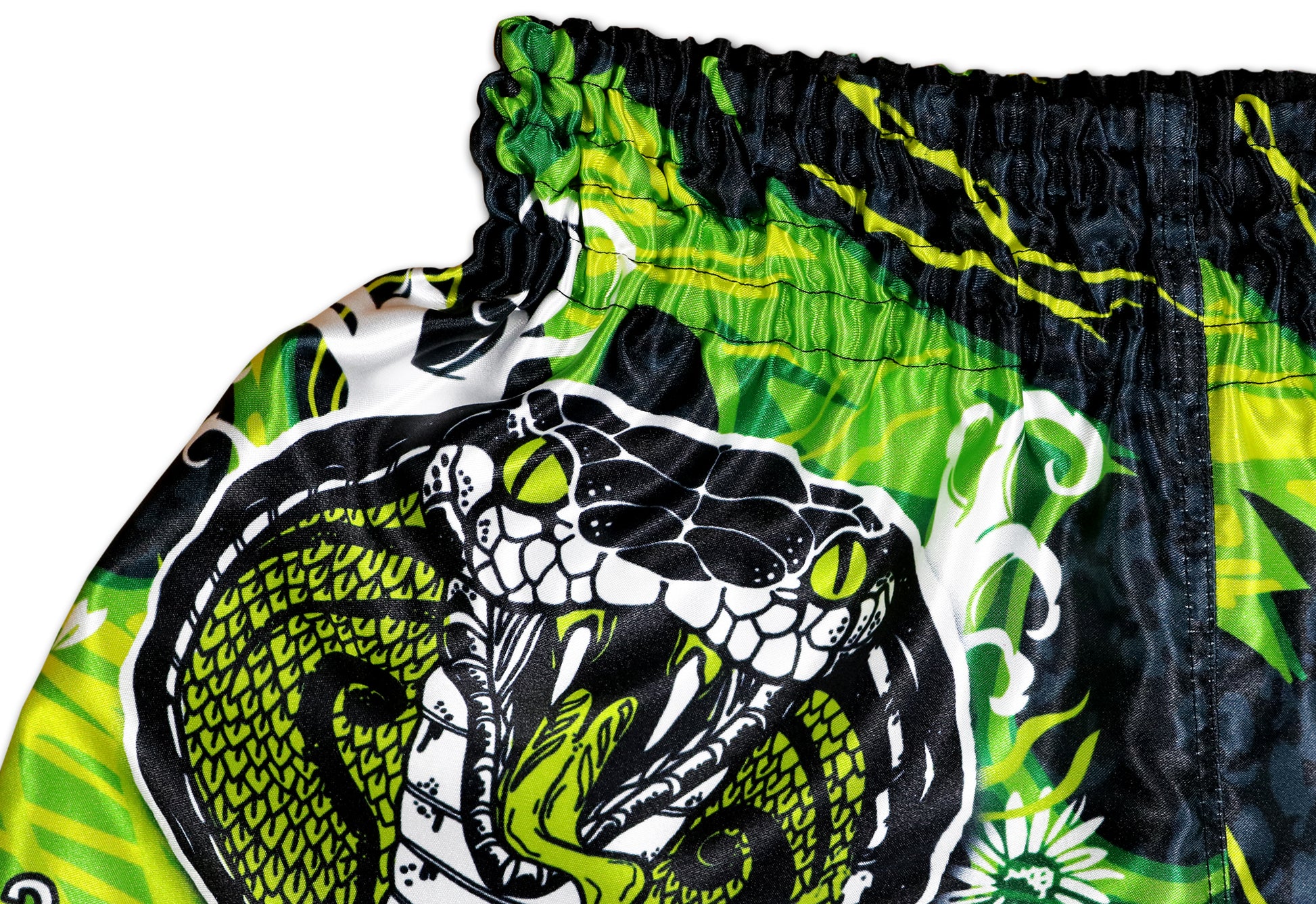 Black Cobra Muay Thai Shorts detail - bold cobra artwork with poison green eyes, premium sublimation print