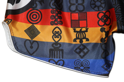 Close up of glossy satin fabric and red blue gold Adinkra symbol stripes on BLACK PANTHER Muay Thai fight shorts