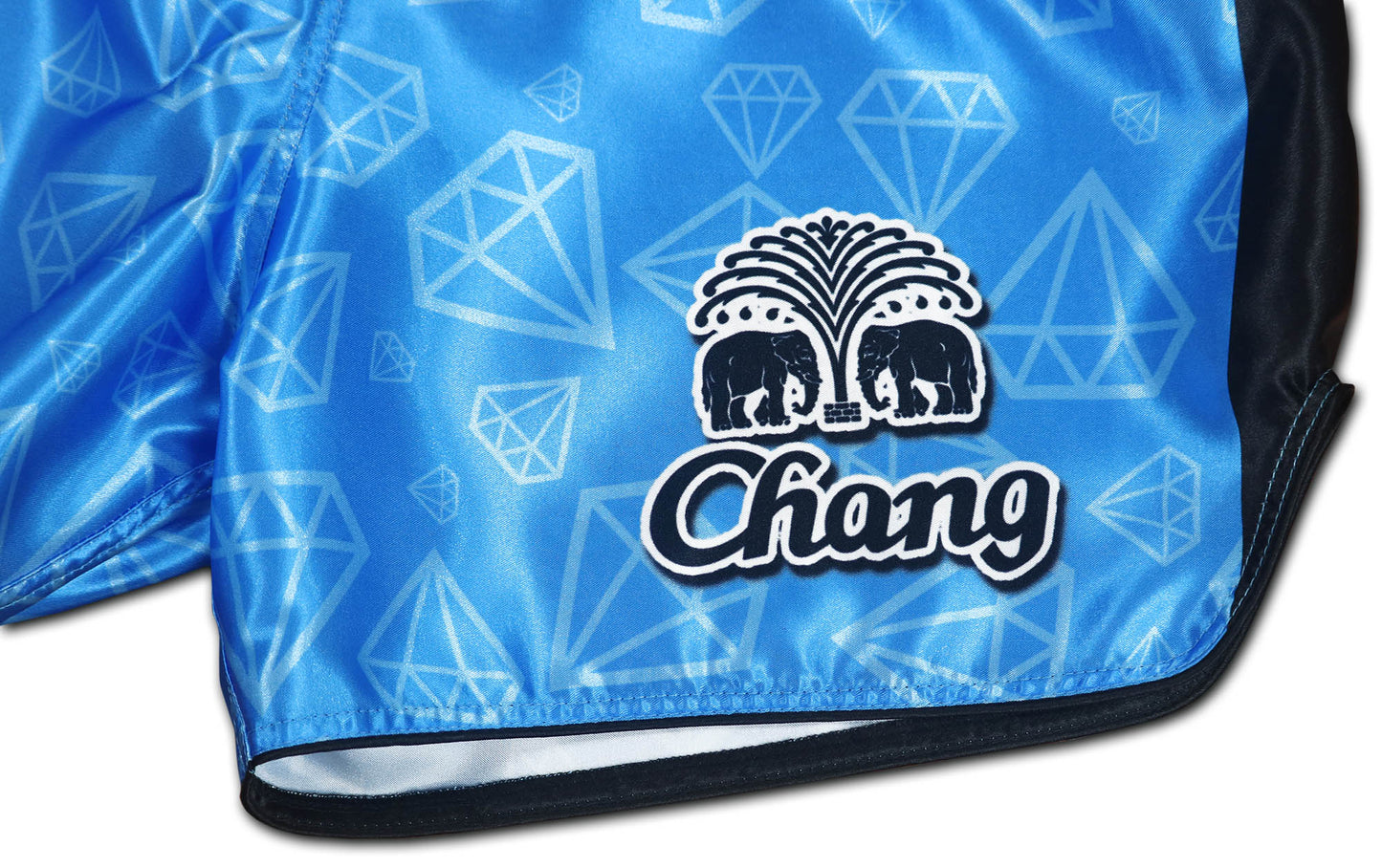 Close up of Chang elephant logo and diamond allover pattern on BLUE CORNER satin kickboxing shorts