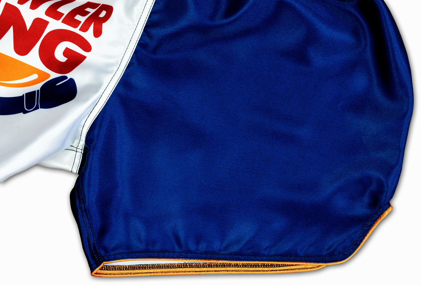 Detail of Brawler King Muay Thai Shorts satin fabric and curved side opening