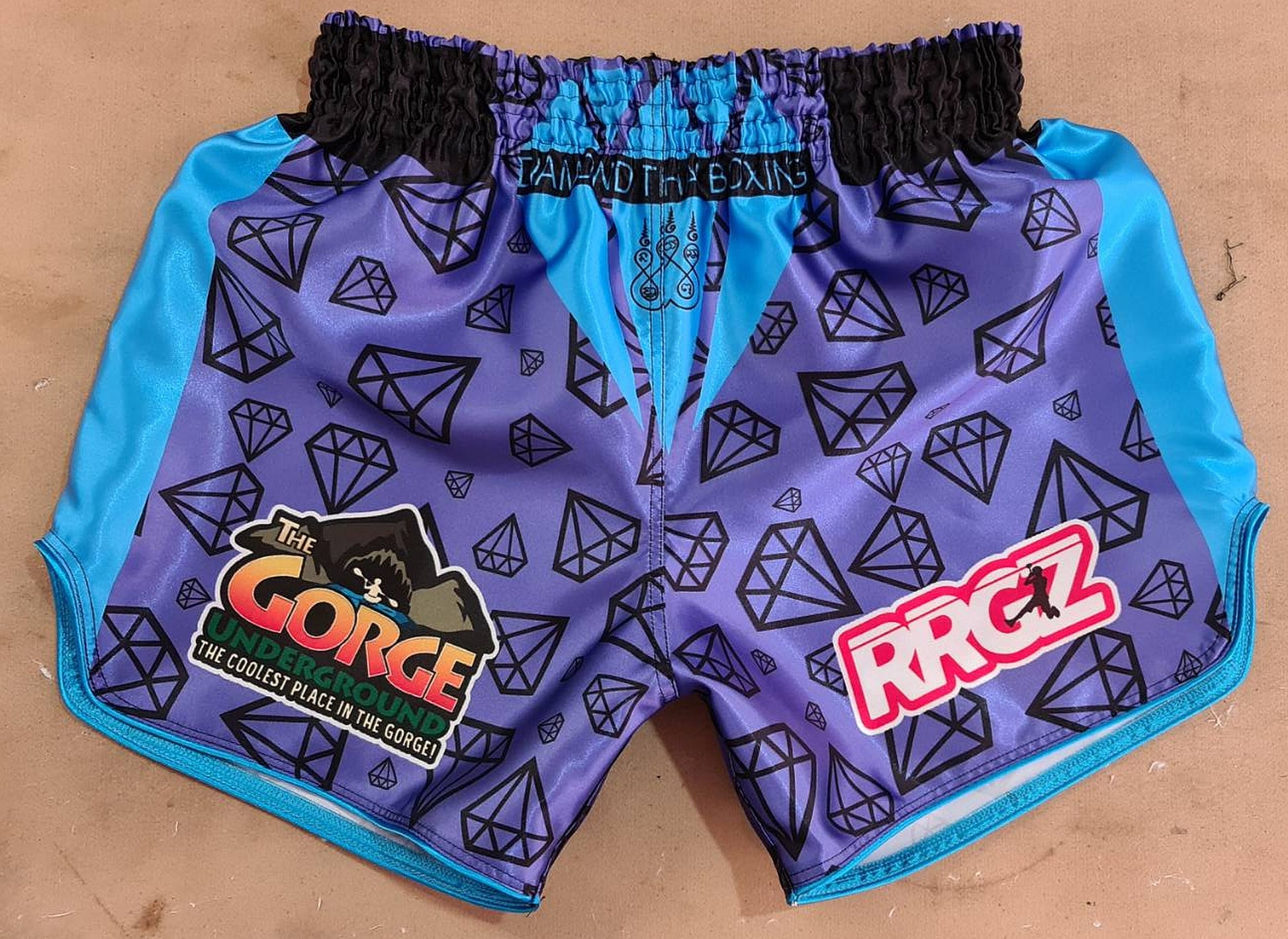 custom made muay thai boxing short with diamond pattern and sponsor logos