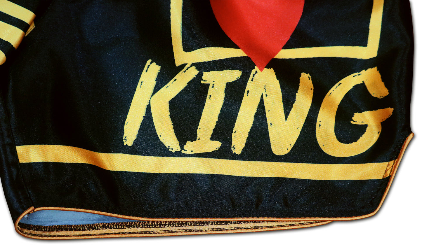 Detail of golden KING lettering and reinforced gold trim on black satin KING Forever Muay Thai Boxing Shorts
