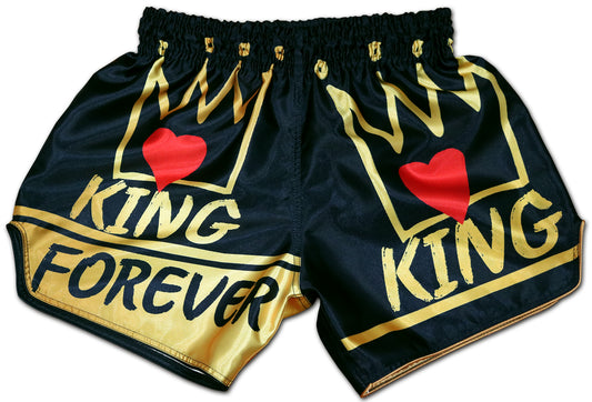 KING Forever Muay Thai Boxing Shorts in black satin with golden crown graphics and red heart accents, front view