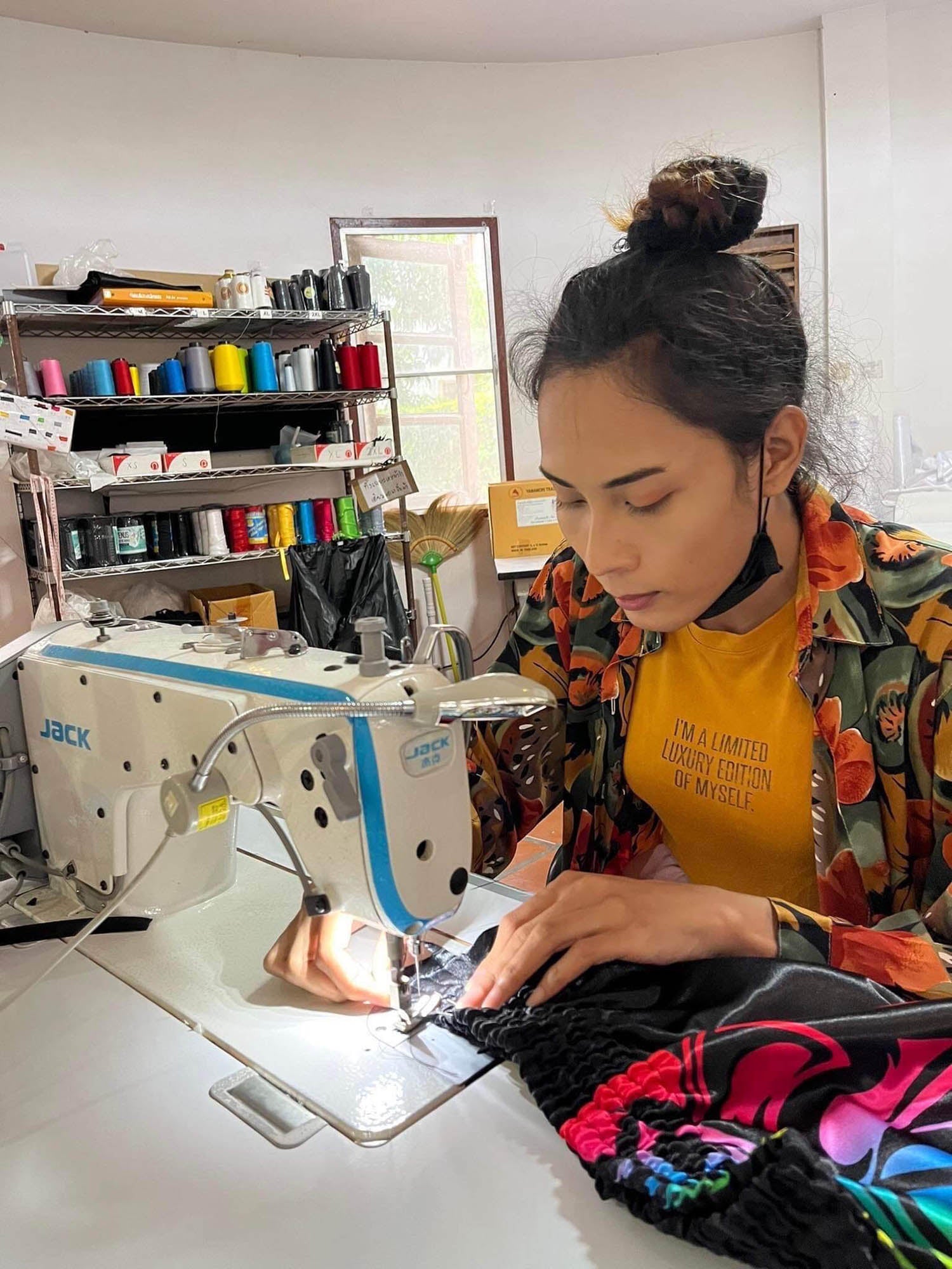 Ladyboy handmaking LGBTQ+ Muay Thai Boxing Shorts in rainbow colors in our family factory in Thailand