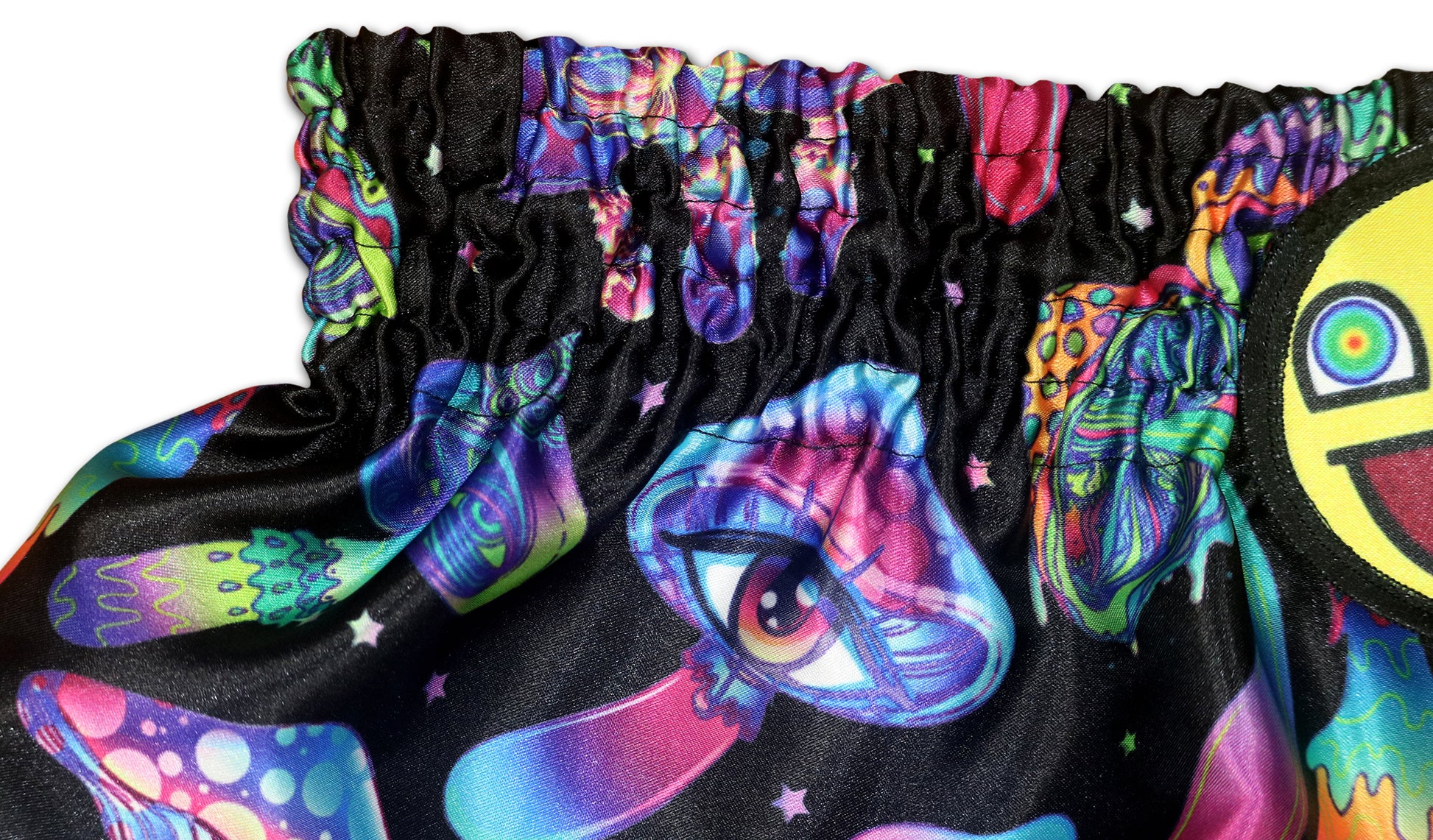 Detail of Magic Mushrooms Muay Thai Shorts waistband with psychedelic mushroom artwork and smiley patch