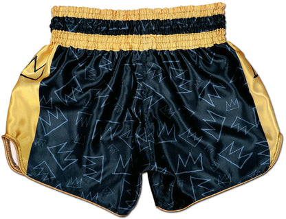 Back view of black and gold Muay Thai King boxing shorts with subtle hand drawn crown pattern across the satin fabric
