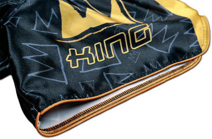 Detail of stitched KING lettering, gold hem and crown graffiti pattern on black satin Thai fightwear