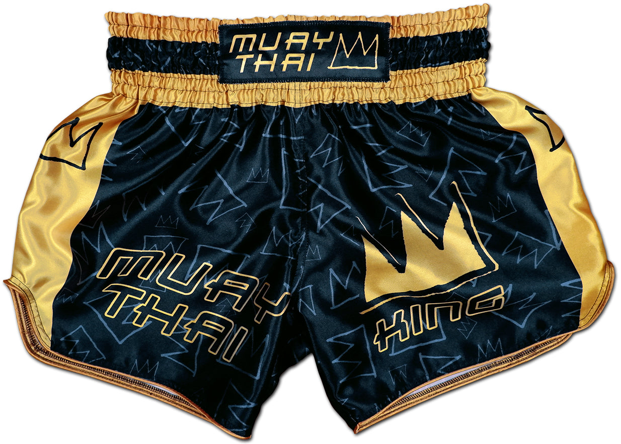 Front view of Muay Thai King boxing shorts in black satin with gold side panels and stitched golden KING crown logo