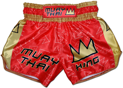 Front view of Muay Thai King boxing shorts in royal red satin with gold side panels and bold stitched KING crown logo