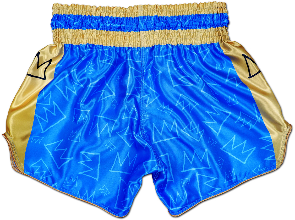 Back view of royal blue and gold Muay Thai King Thaiboxing shorts with subtle hand drawn crown pattern across the satin