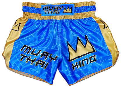 Front view of Muay Thai King Thaiboxing shorts in royal blue satin with gold side panels and stitched KING crown logo