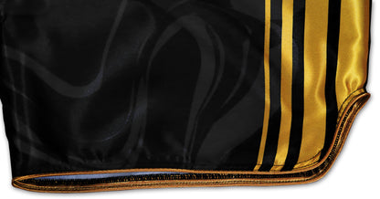 Kickboxing Shorts detail showing elaborately processed gold borders and gold stripes on black satin