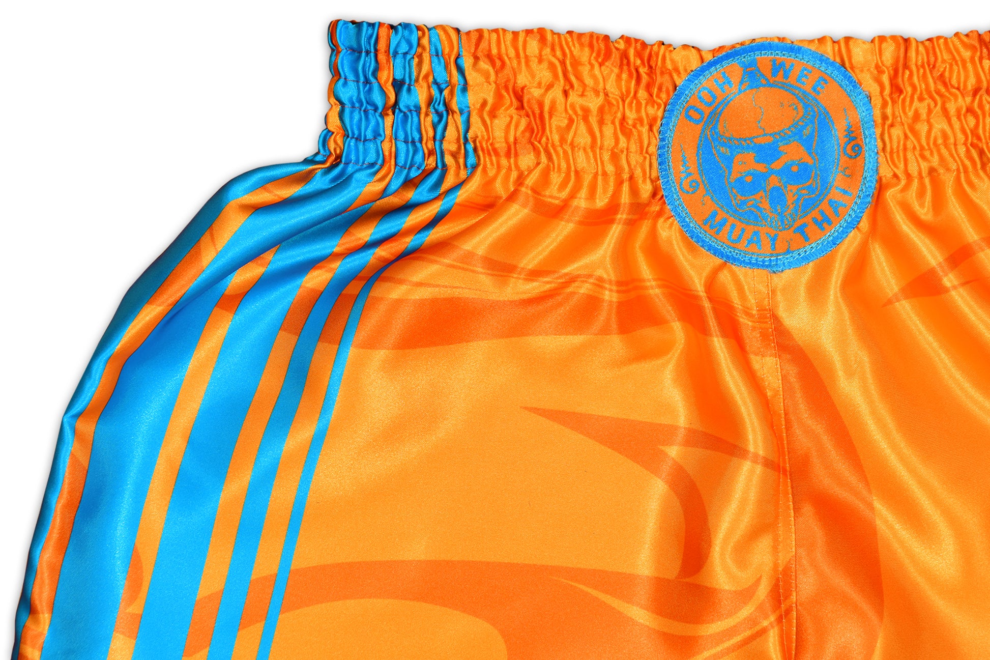 Close up picture of the OOWEE Muay Thai Shorts showing blue stripes and smoke liquid design on vibrant orange premium satin