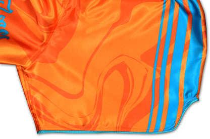 OOWEE Muay Thai Shorts detail showing blue stripes and smoke liquid design on vibrant orange premium satin