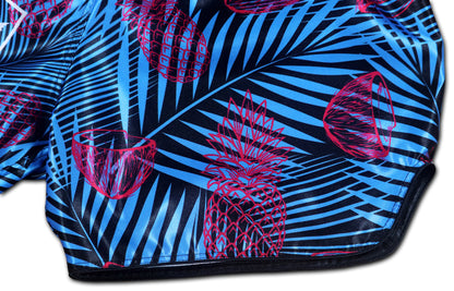 OOWEE Tropical Thai Boxing Shorts detail showing pink pineapples and coconuts on blue palm leaves premium sublimation print