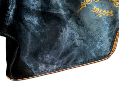 Close up of black elastic waistband and gold Sak Yant sacred Thai script on Phaya Naga fight shorts in black satin
