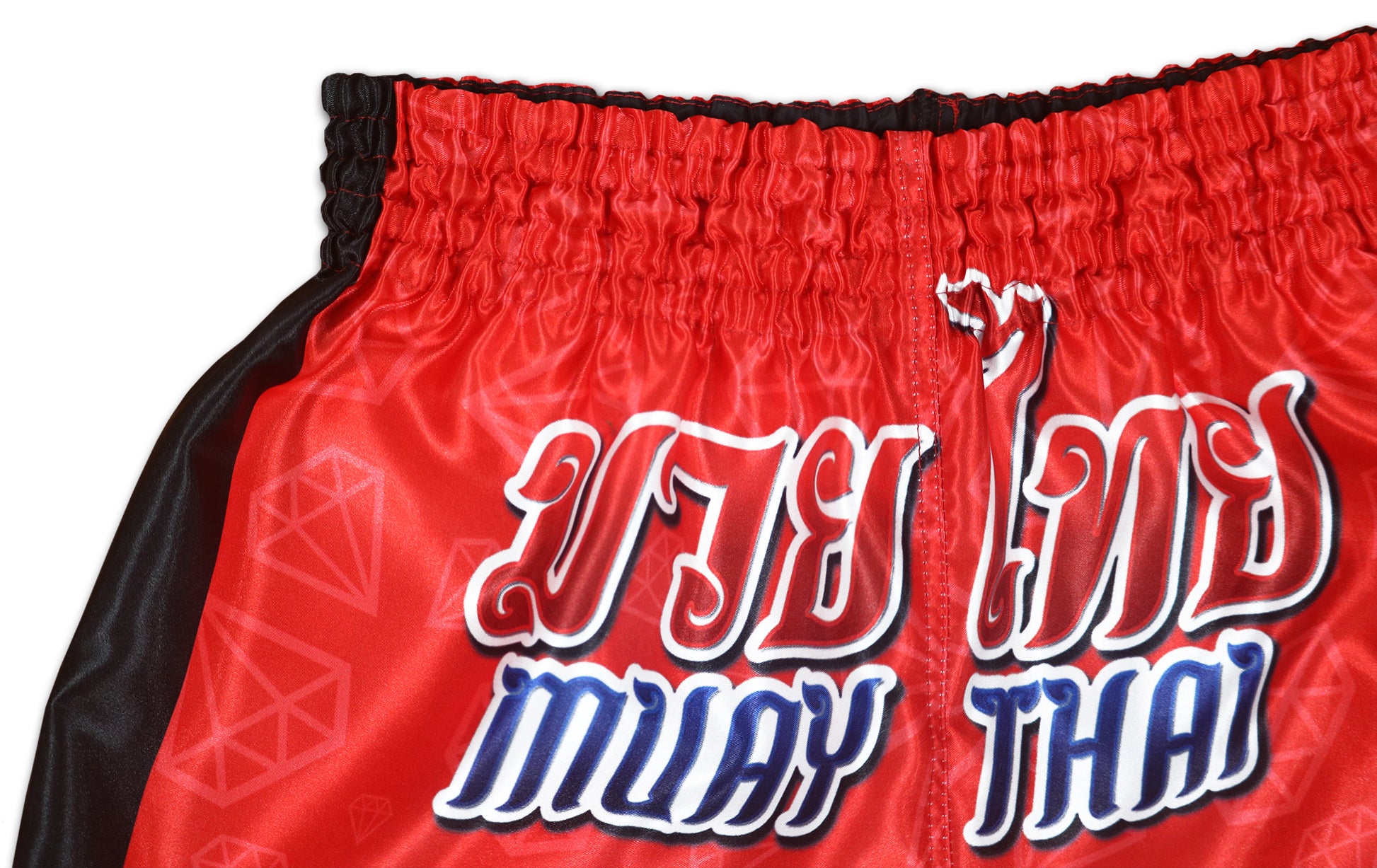 Close-up of classic Muay Thai lettering printed on glossy red satin Red Corner fight shorts