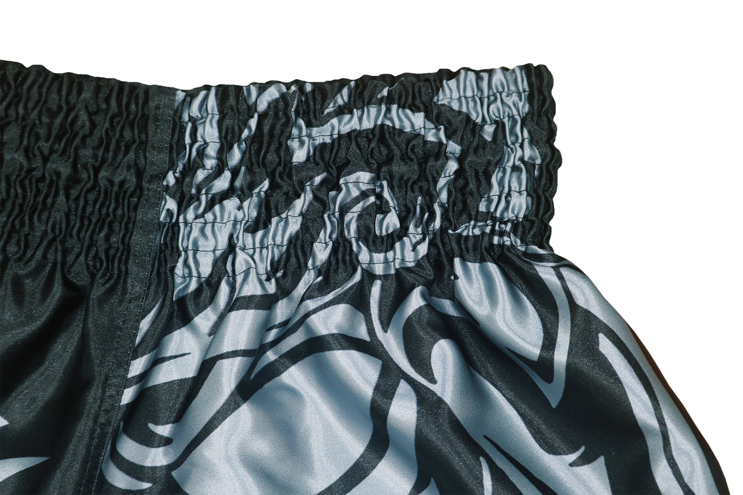 Close up of black elastic waistband and silver gray tribal pattern on Samurai Stealth satin training shorts