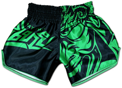 Front view of black satin Thaiboxing shorts with tribal samurai mask graphic and toxic green MUAY THAI lettering