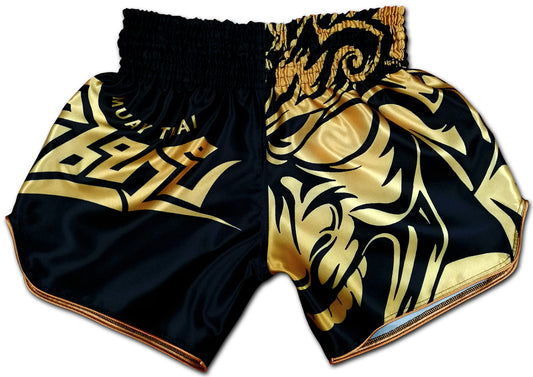 Tribal Samurai Muay Thai Boxing Shorts Black Gold front view with golden tribal demon mask, Thai script and bold lettering on premium satin