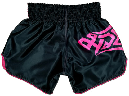 Back view of black satin women's Thai fightwear shorts with pink tribal lettering, contrast pink piping and clean stitching