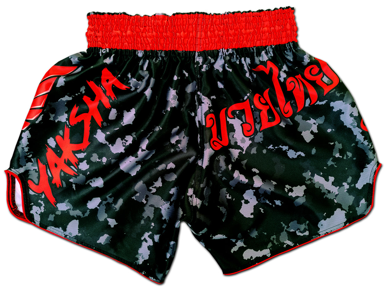 Black Red Camouflage fightshorts back view, red YAKSHA logo and Thai script on black camo satin with red trim