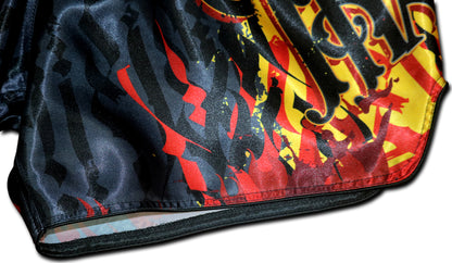 Close up of YAKSHA Firestarter Thai boxing shorts waistband with red YAKSHA logo and red orange fabric detail