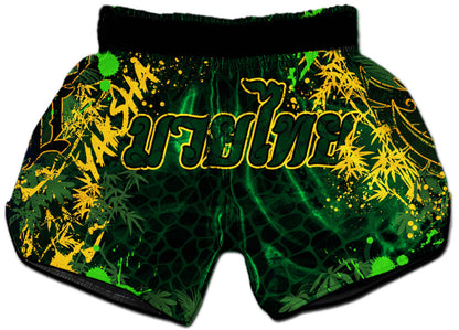 YAKSHA Rumble in the Jungle Fight Shorts back view, deep green jungle texture with gold bamboo leaf print and YAKSHA lettering