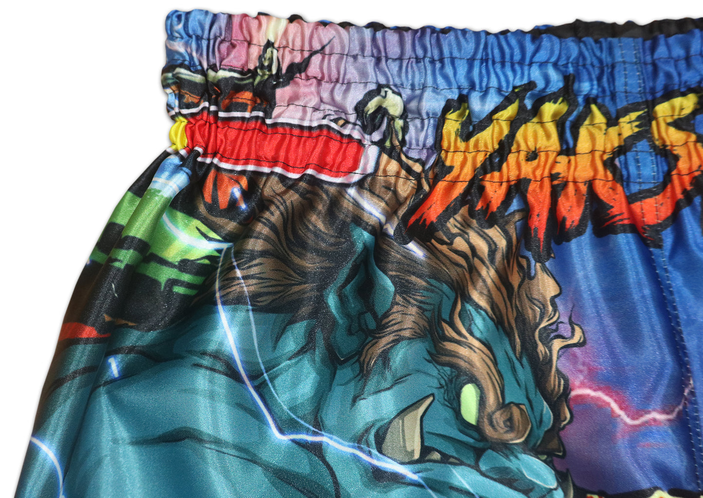 Detail of YAKSHA flame logo and elastic rubber waistband on Street Fighter shorts